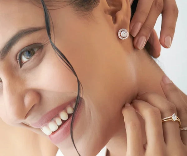 Woman wearing diamond earrings with a close-up of the jewelry.