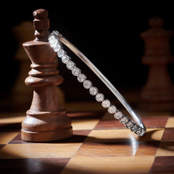 Diamond bracelet on a wooden chess piece with a chessboard background