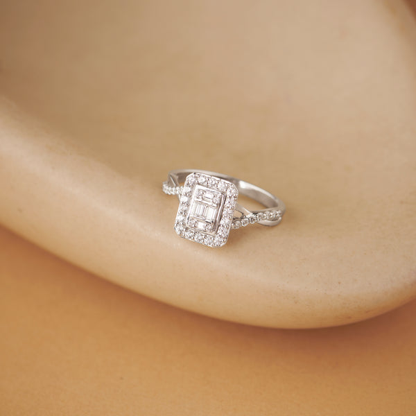 Silver ring with diamonds on a beige background