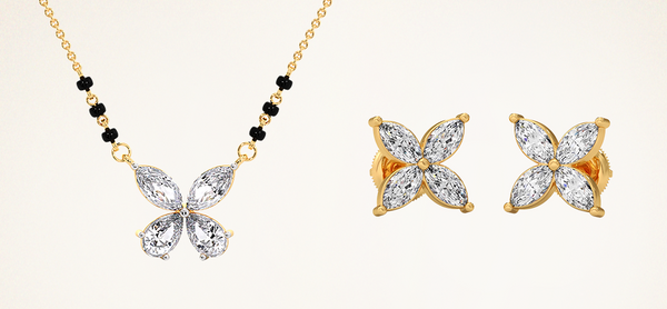 Butterfly-shaped gold jewelry set with necklace and earrings on a beige background