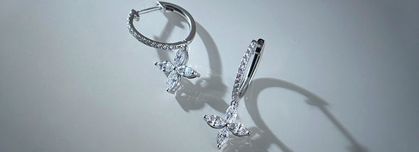 Butterfly-shaped earrings on a light gray background