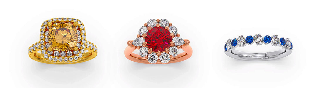 Three jewelry items: a gold ring with a yellow gem, a rose gold ring with a red gem, and a silver ring with blue and white stones on a white background.