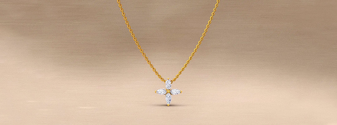 Gold necklace with a diamond pendant on a beige background