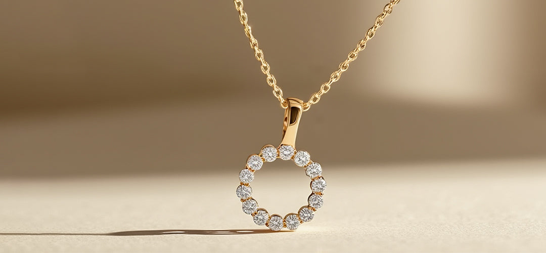 Gold necklace with a round diamond pendant on a beige background