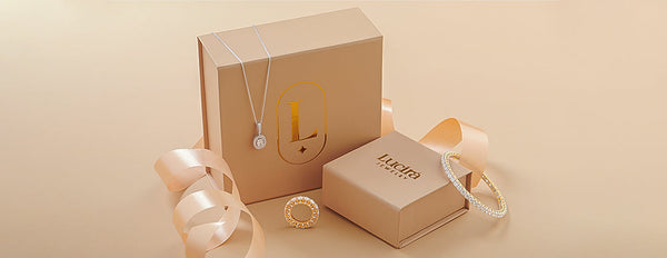 Jewelry set with necklace, ring, and bracelet on a beige background with 'Lucira Jewelry' branding.