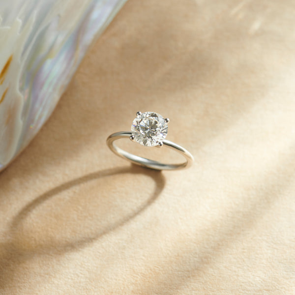 Diamond ring on a beige fabric background