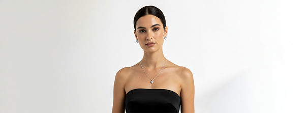Woman wearing a black strapless top against a white background