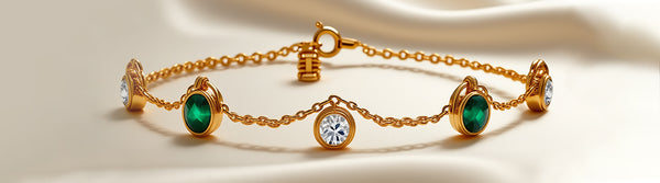 Gold bracelet with emerald and diamond stones on a beige background