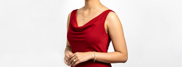 Woman wearing a red sleeveless top on a plain background