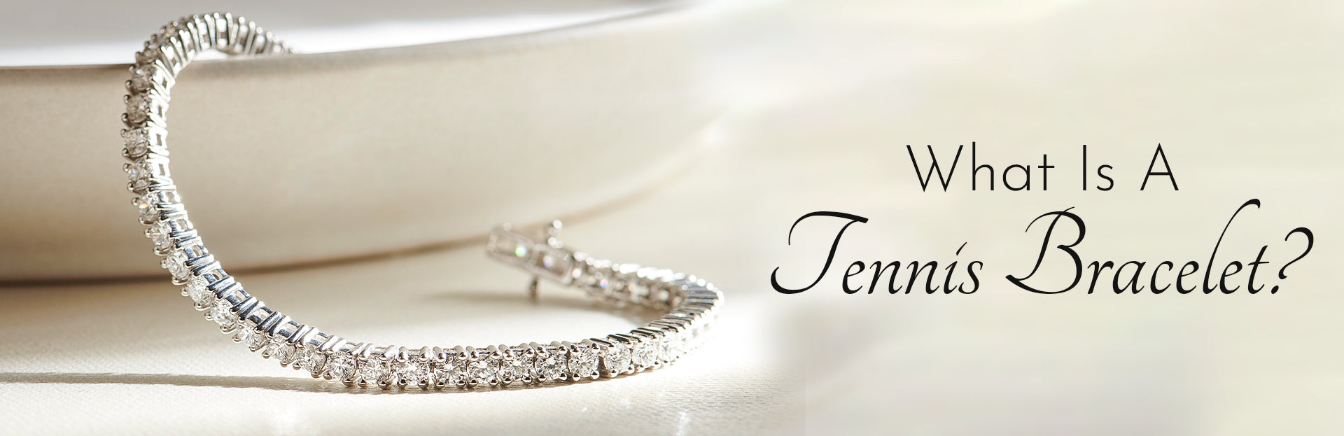 Silver tennis bracelet on a light background with text asking 'What Is A Tennis Bracelet?'