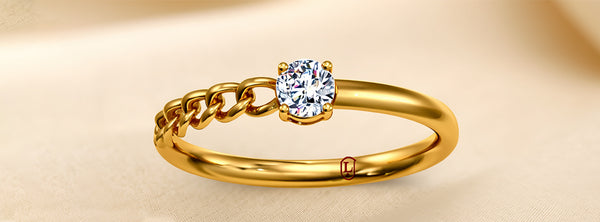 Gold ring with a diamond on a beige background