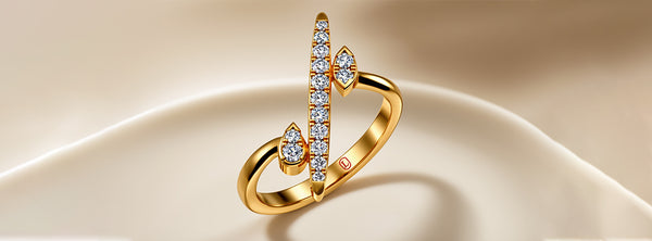 Gold ring with diamond accents on a beige fabric background