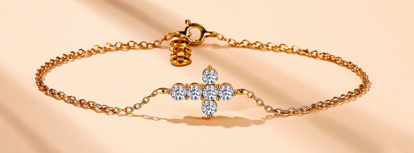 Gold bracelet with a decorative clasp on a beige background