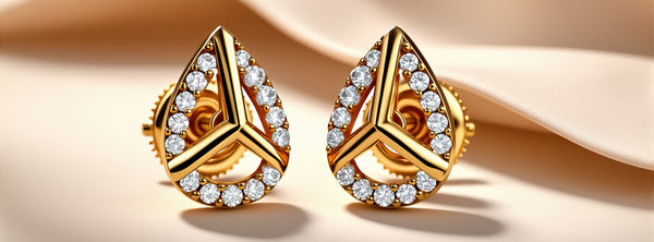 Gold teardrop earrings with diamond accents on a beige background