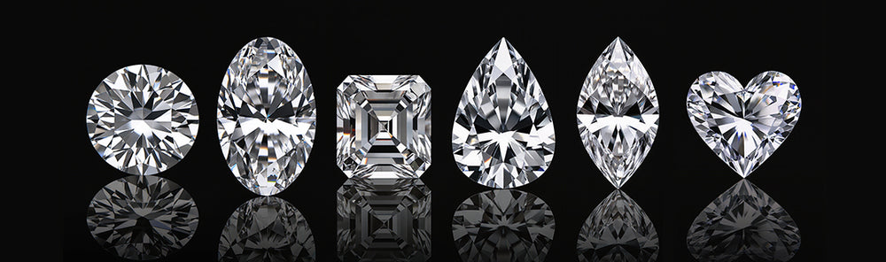 Collection of various cut diamonds on a black background