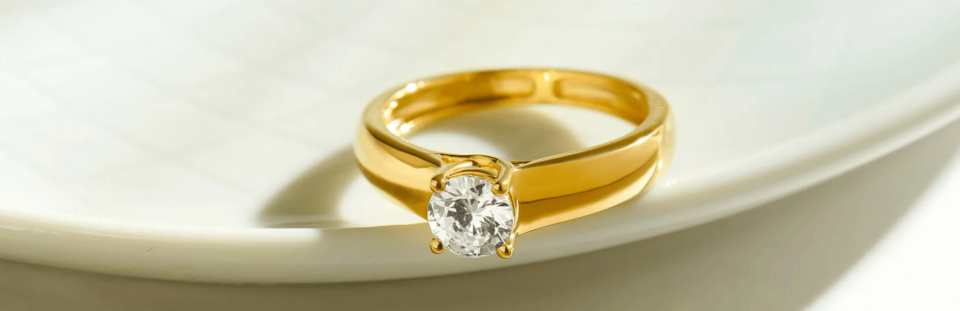 Gold ring with a diamond on a white background
