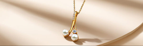 Gold necklace with pearl pendant on a beige background